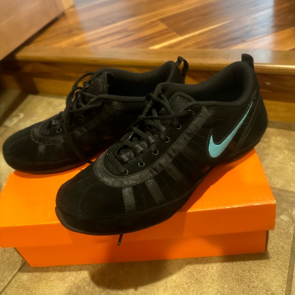 Brand new Nike black shoes with blue Nike sign. Size 9.